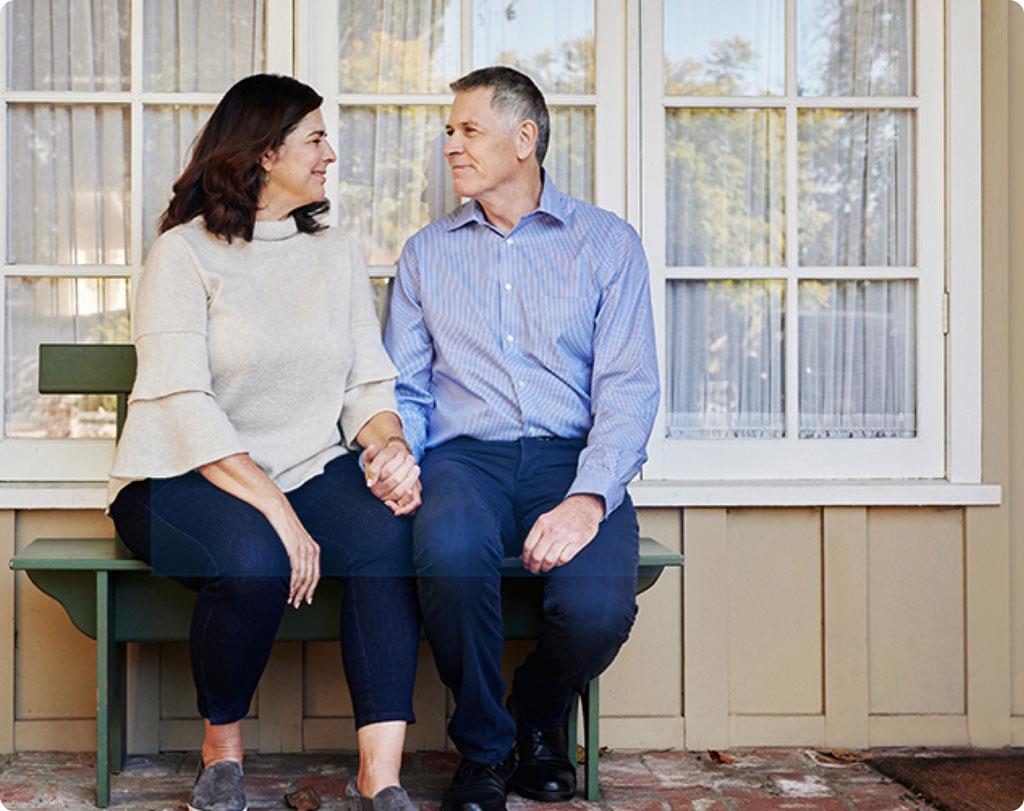 Happy couple sitting on a bench